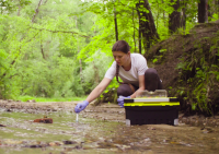 Water Resources Cover Water Resources Technician sampling a creek