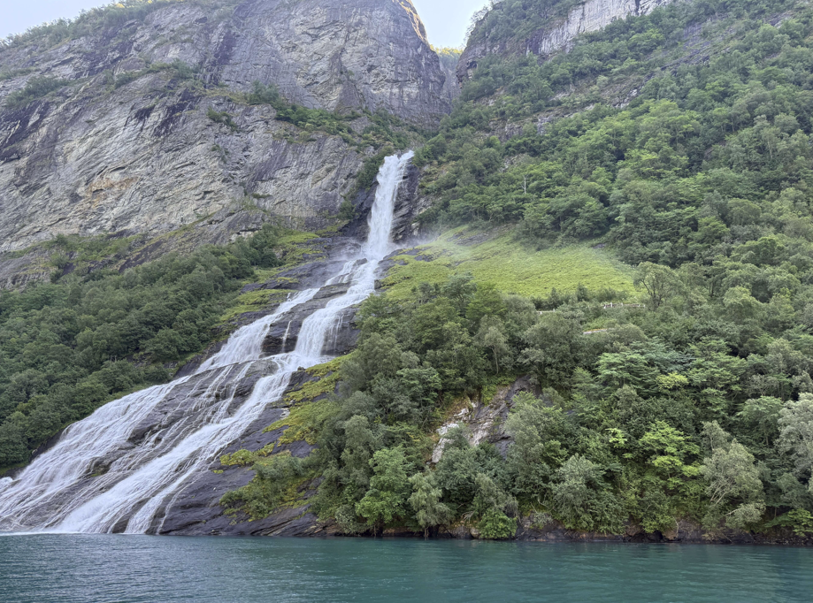 This is an image of a waterfall in a village called Geiranger in Norway.