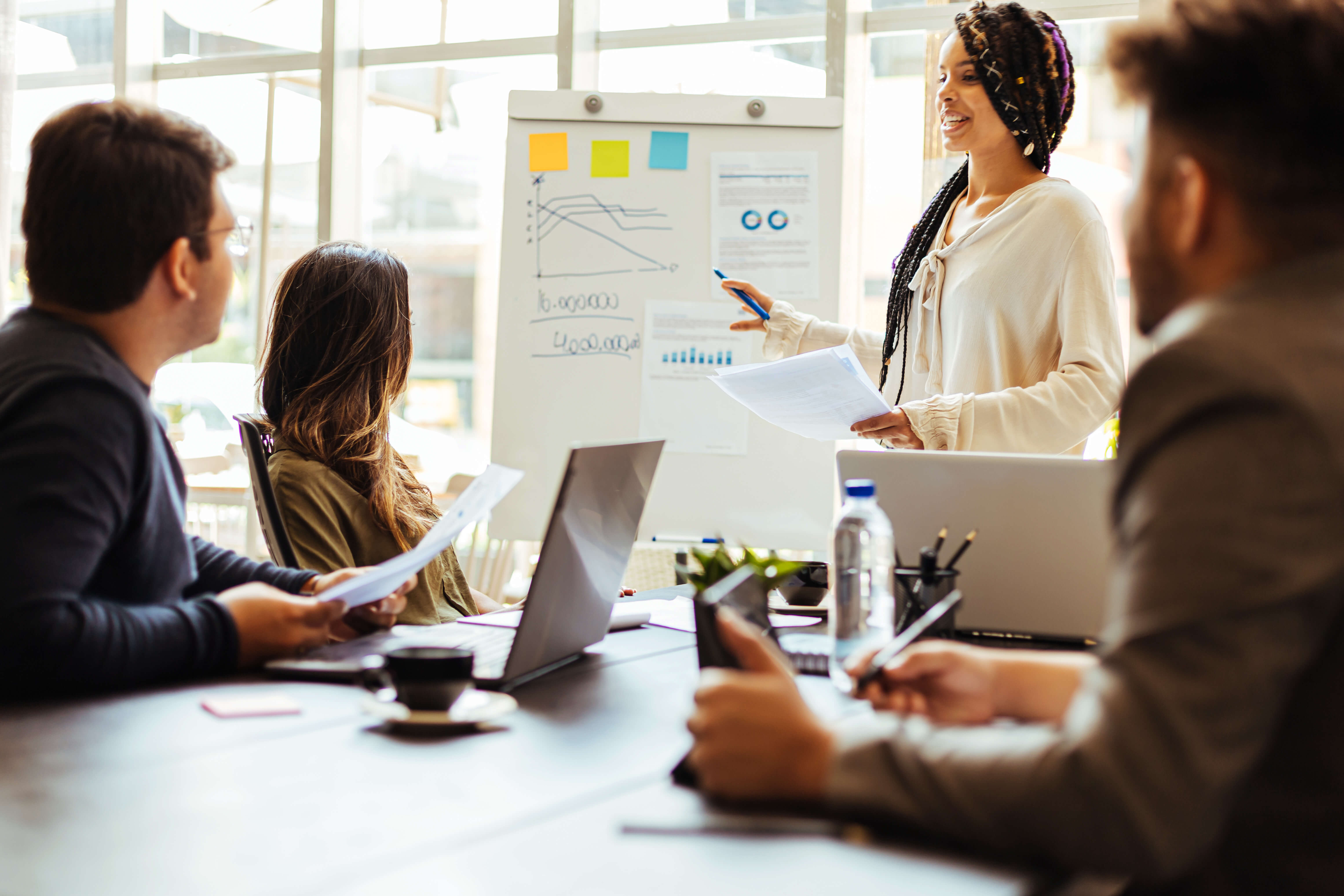 This image shows a professional communicating complex data to non-experts during a meeting.